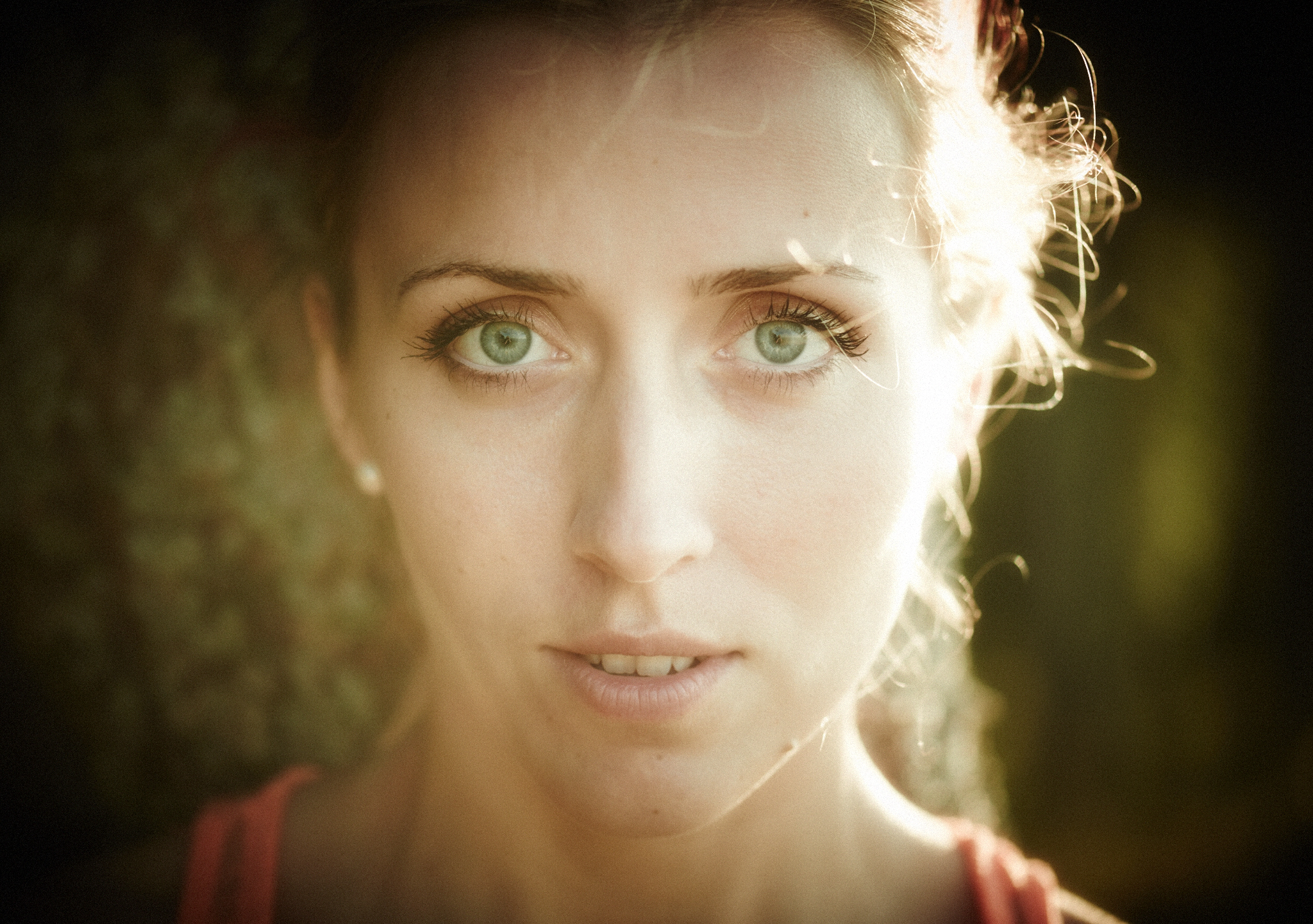 a woman with green eyes looks at the camera