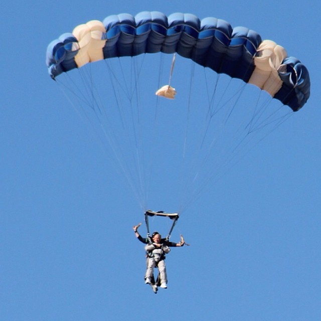 a person who is parasailing in the air