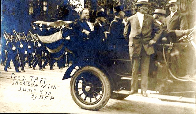 a group of men in hats and suits standing next to an old car