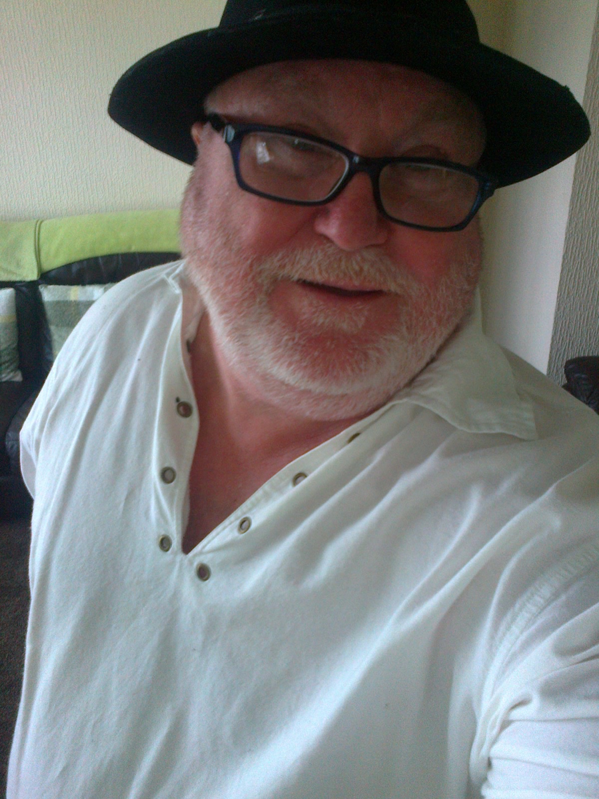 a man in a black hat and glasses