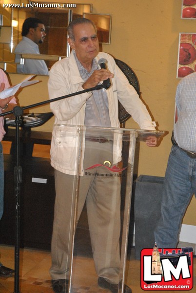 a man standing in front of a microphone speaking
