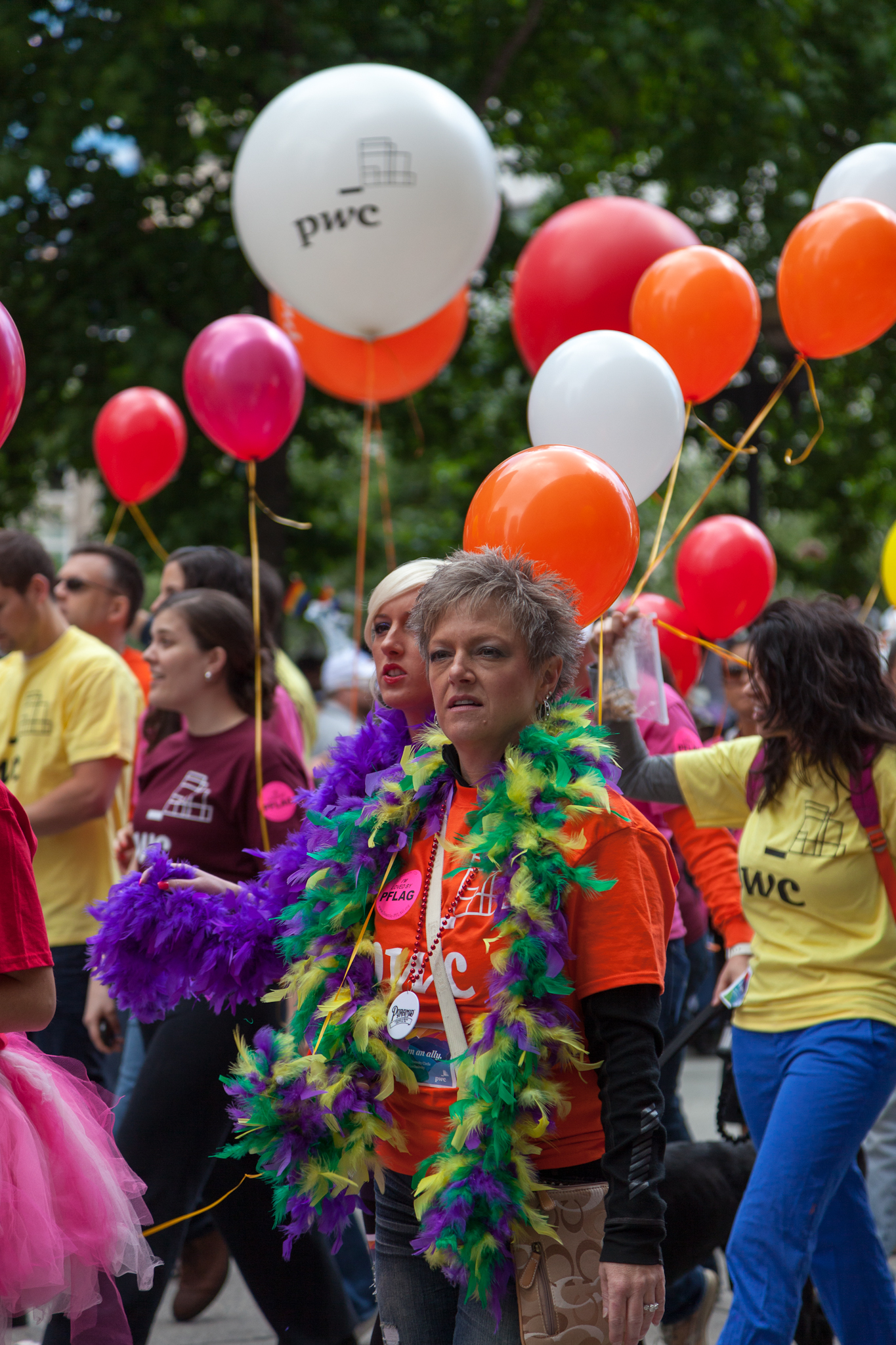 people are on the street in parade clothes and wearing clown hats