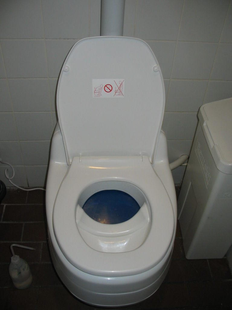 a toilet with a blue on on the seat
