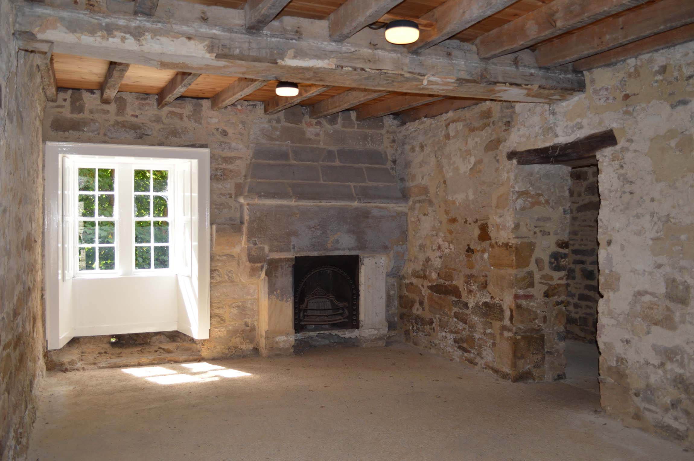 this room has stone walls and windows on both sides