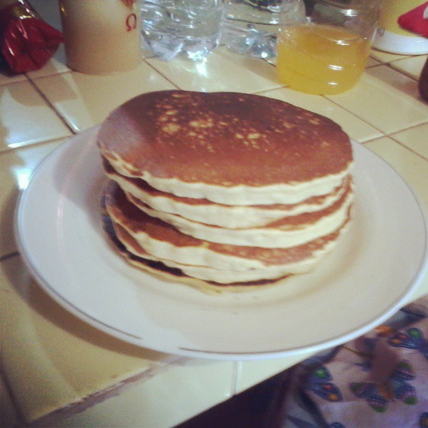 a stack of pancakes on a white plate