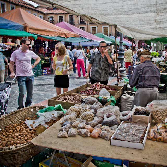 people shopping in an outdoor farmers market