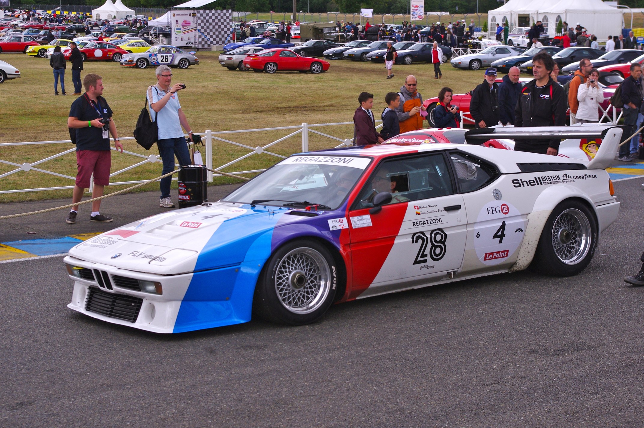 a car painted with a paint job is parked on a race track