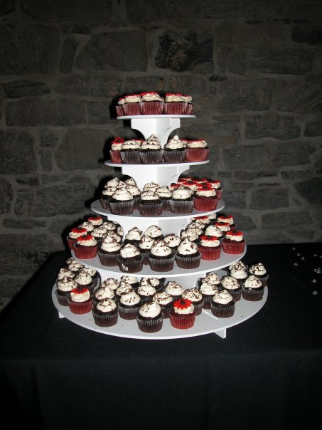 four tier cake with chocolate cupcakes on the bottom