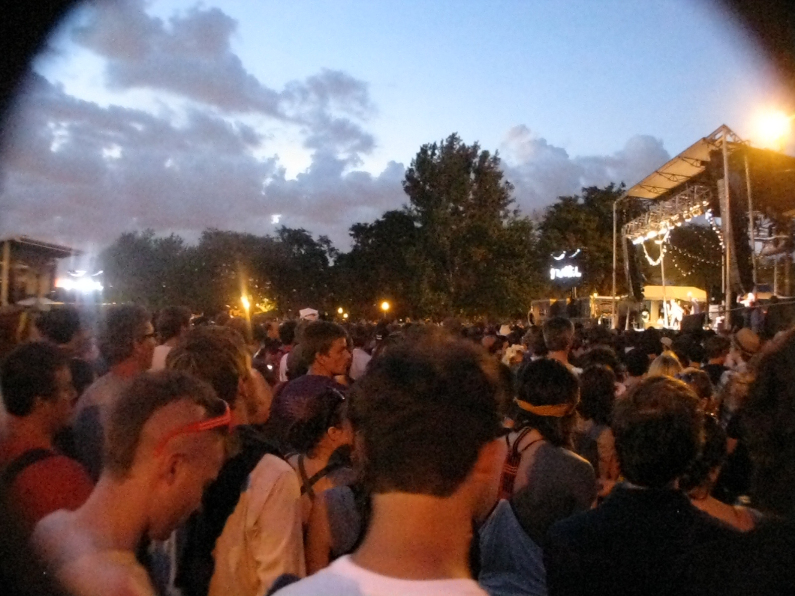 a crowd in the evening as they watch the stage