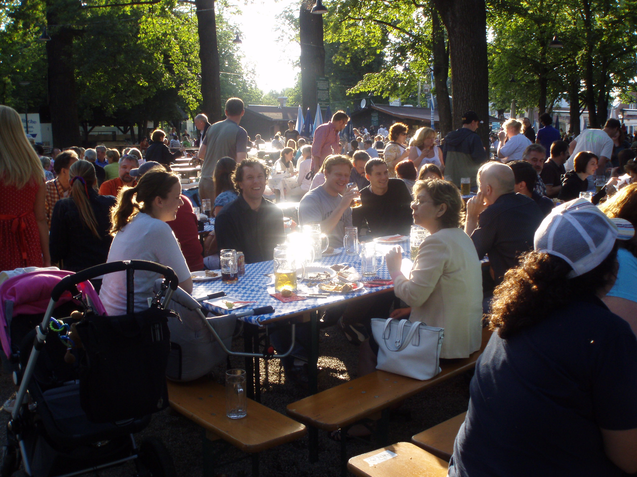 a group of people sitting and standing around tables