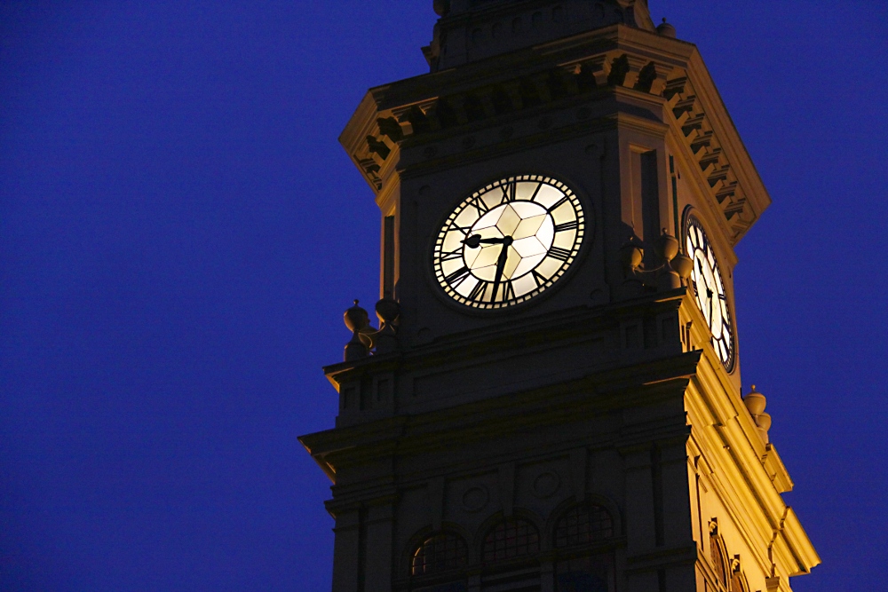 a large clock tower that has a light on the top