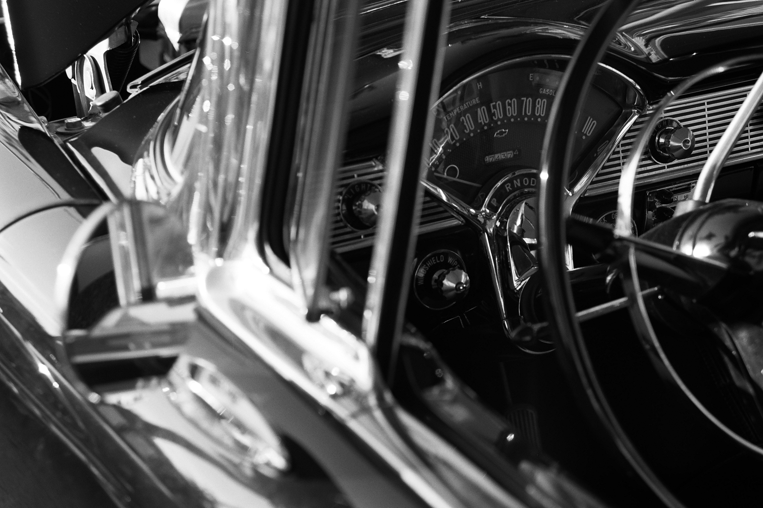 an old, black - and - white po shows the dash board of a classic car