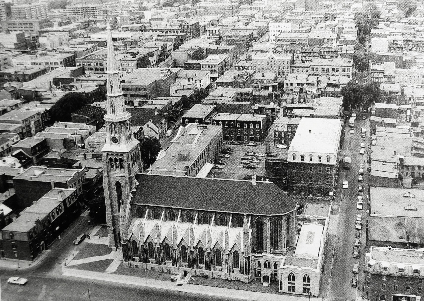 an old aerial po of a city and a big long building