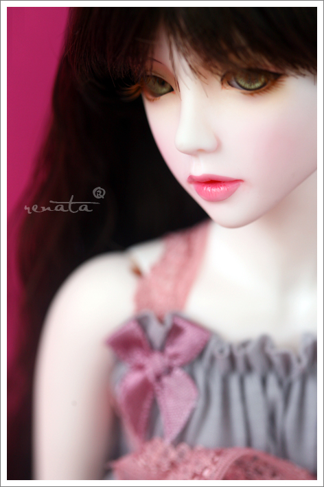 a close up of a doll with dark hair