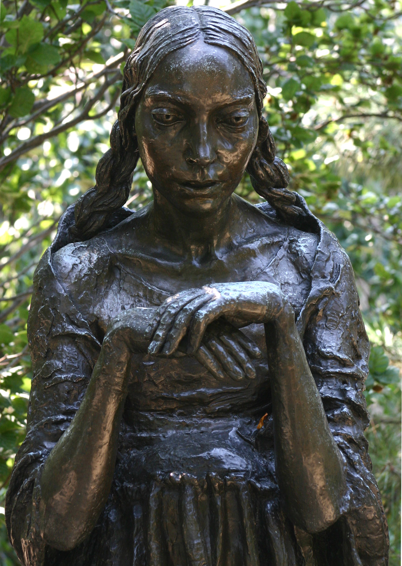 a statue with a bird perched on her hand