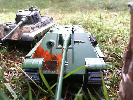 a toy tank is laying out on the ground