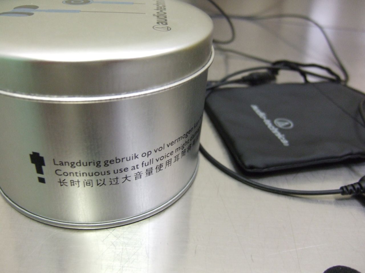 a tin containing various types of electronics on top of a table