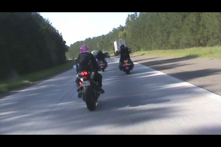 a group of motorcycles traveling down the road