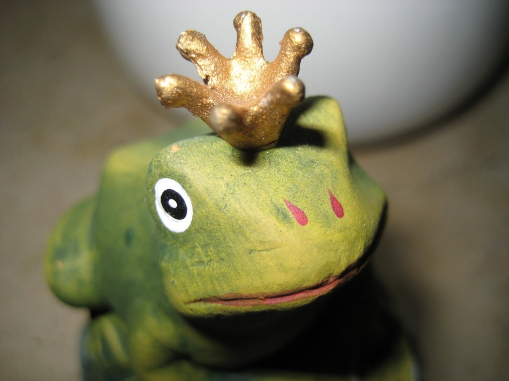 a close up of a small frog figurine