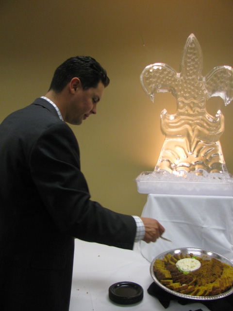 a man wearing a black jacket slicing food