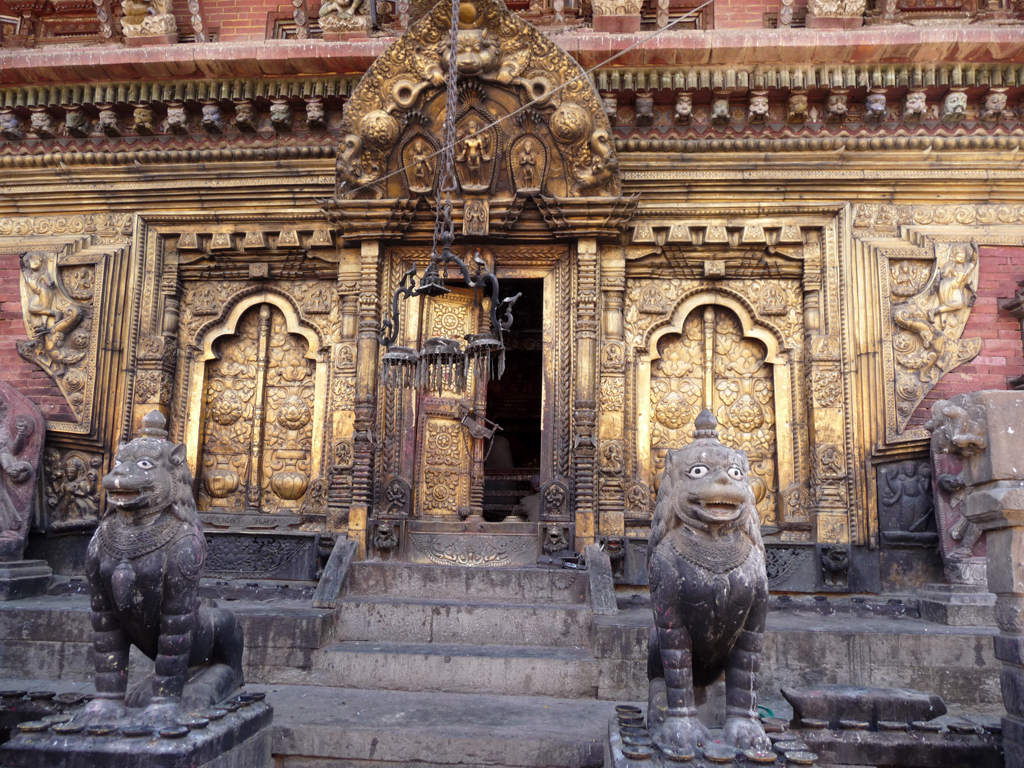 statues on steps leading to a very ornate doorway