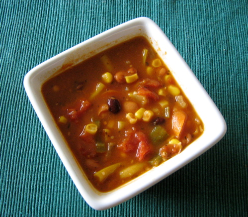 a bowl of soup on a table with blue background