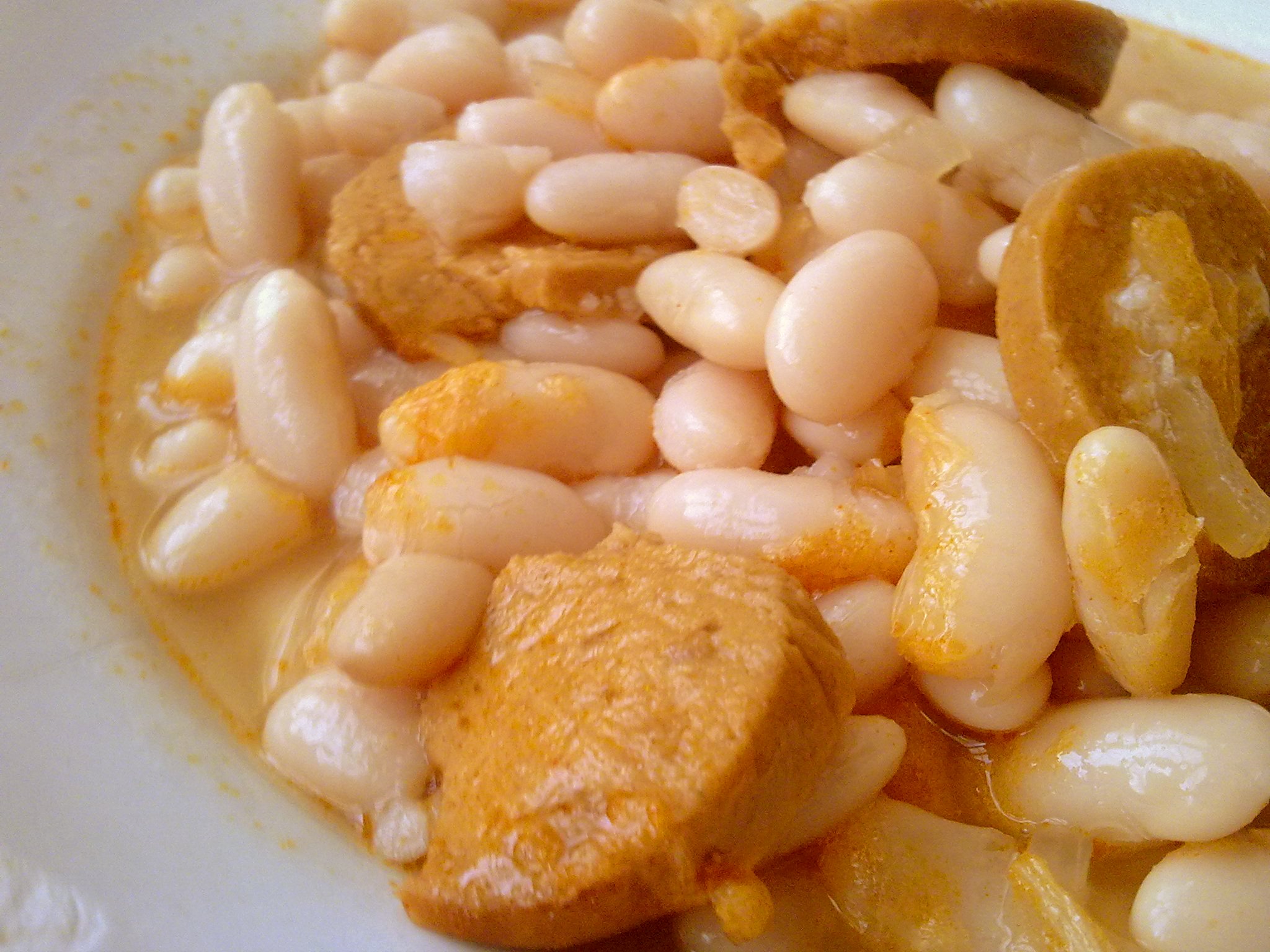 a bowl of some type of soup with beans and carrots