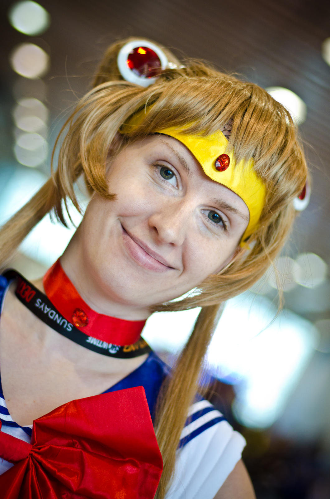 a girl with long red hair wears a yellow hairband