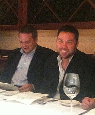 two men sitting at a restaurant table