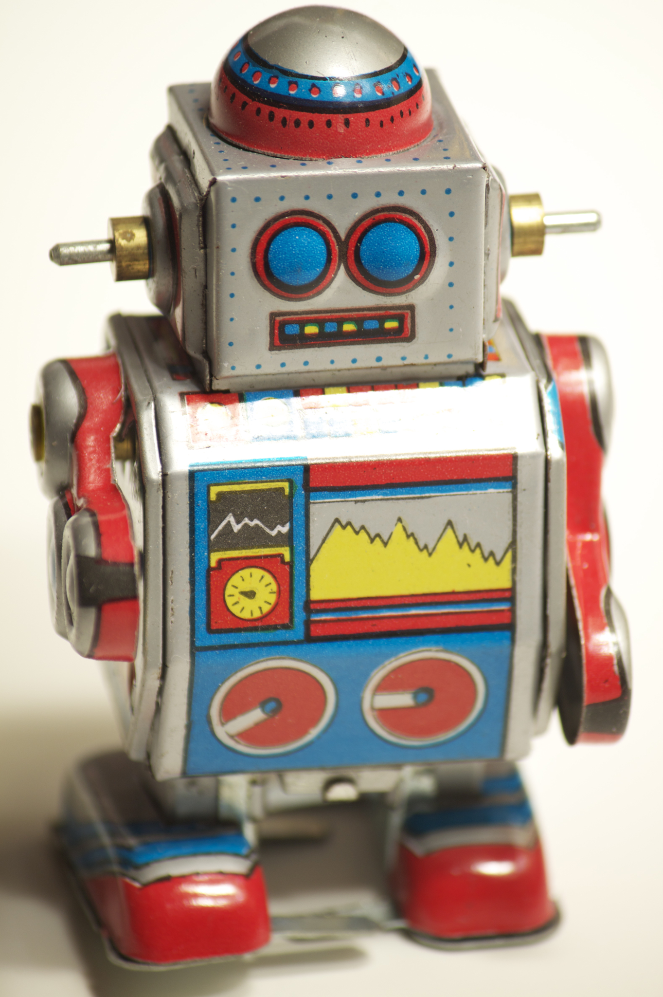 this is a small tin toy robot that looks like it is making a turn