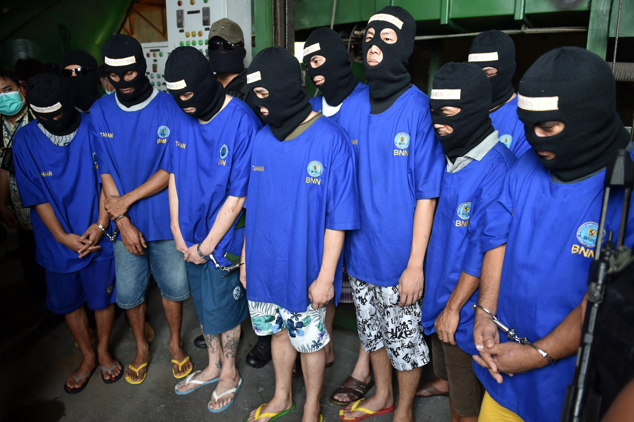 several people are wearing face masks and standing together