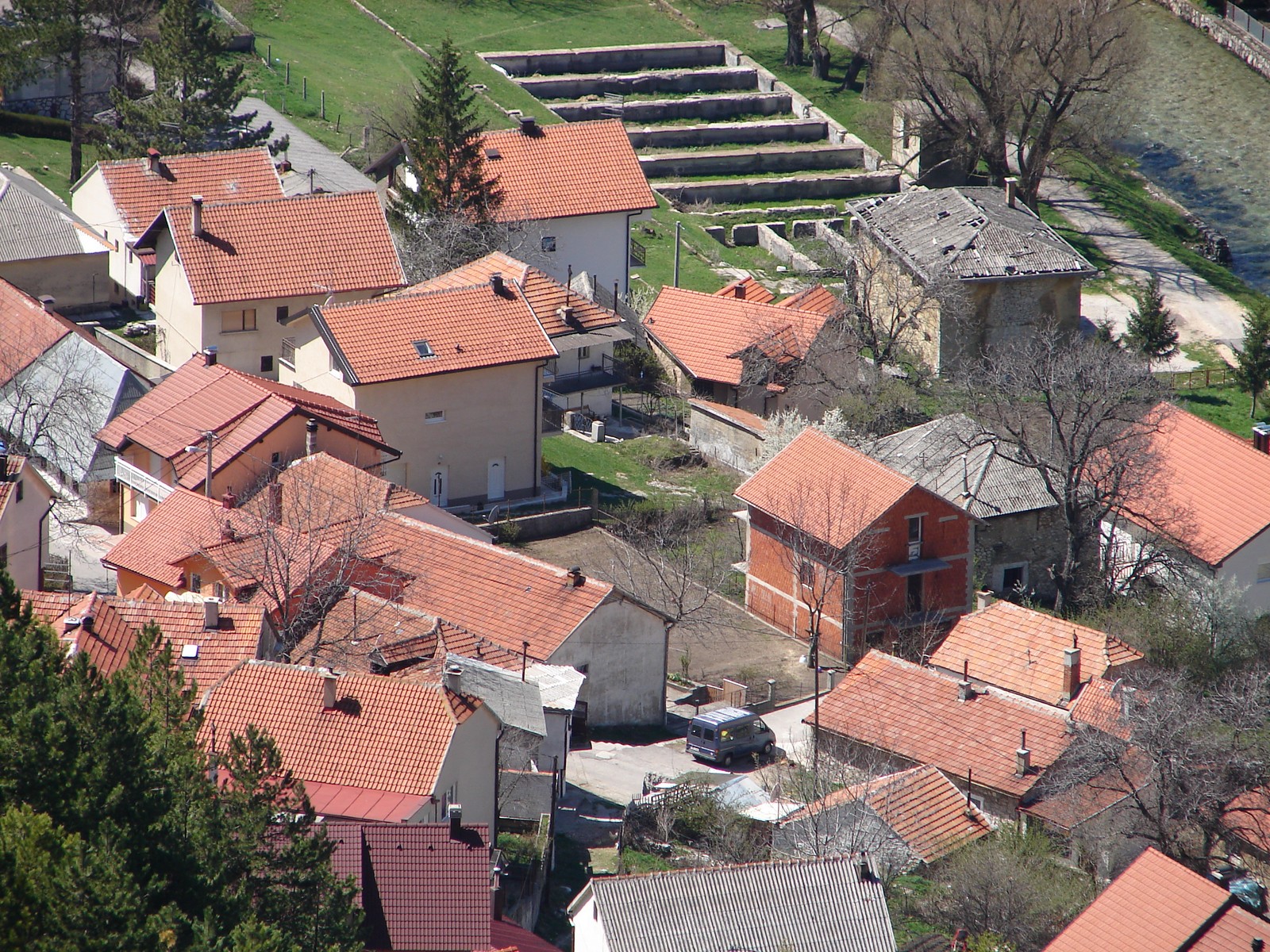 an aerial view of a city area with houses and trees