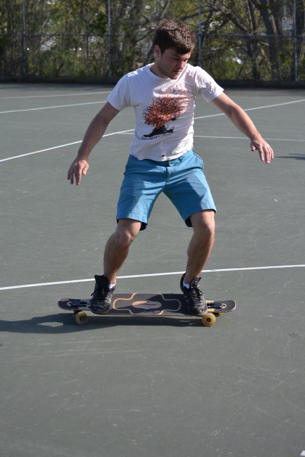 man riding a skateboard on a concrete surface