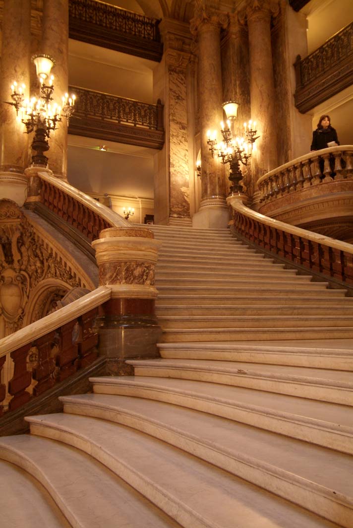 this is a fancy stone stairs with fancy chandeliers and lamps