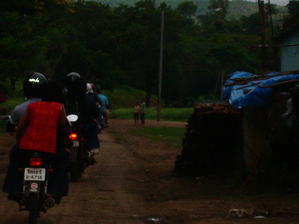 people riding on bikes on a dirt road