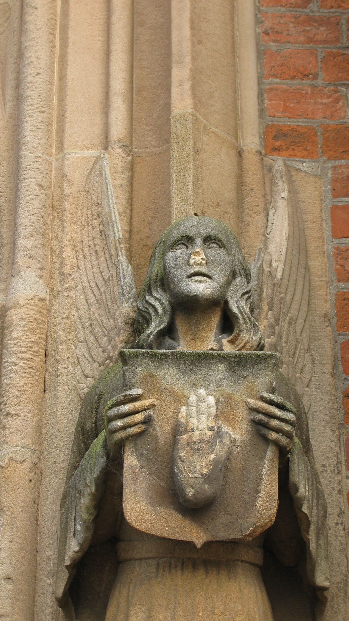 an angel statue on a stone face and wings