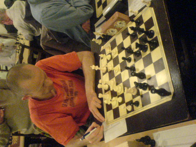 a man plays chess in an open room