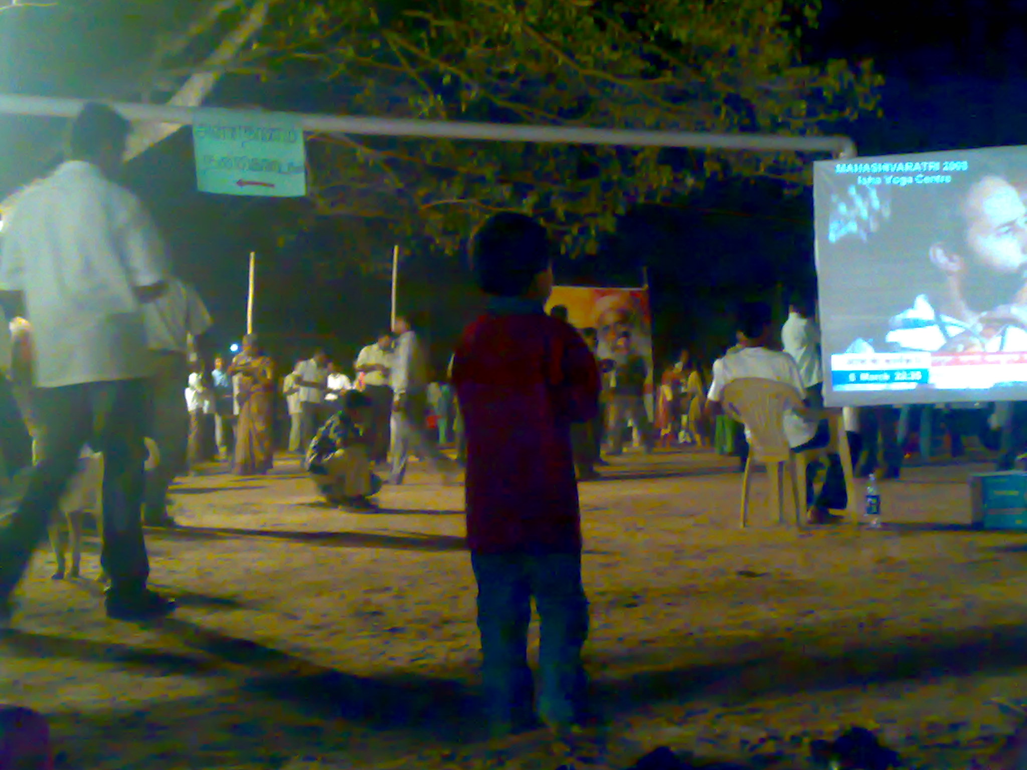 a blurry picture of people at an outdoor park and television screen