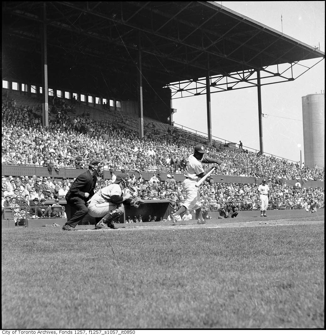 a man standing on a field with a baseball bat