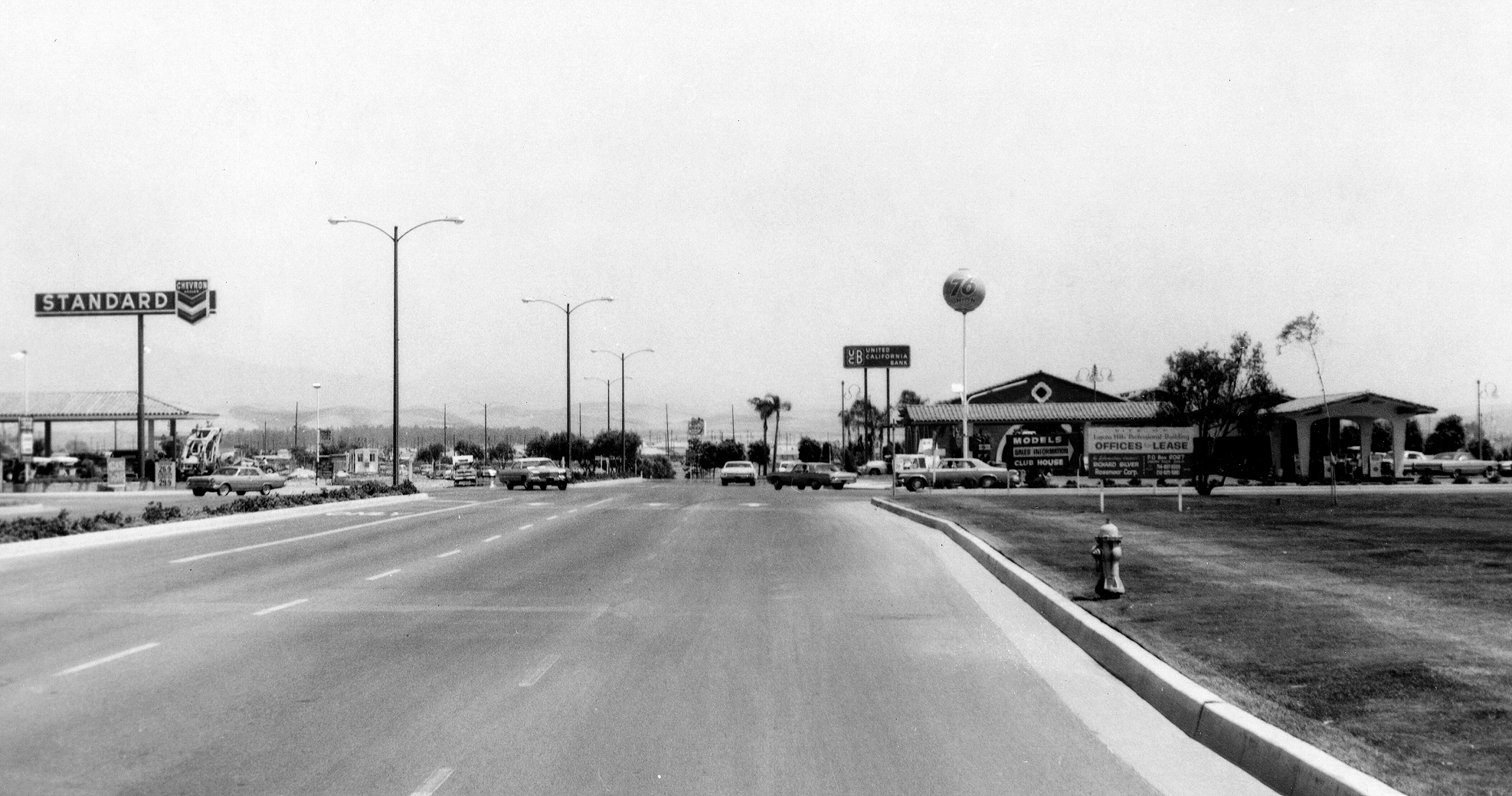 black and white po of a street with gas pumps