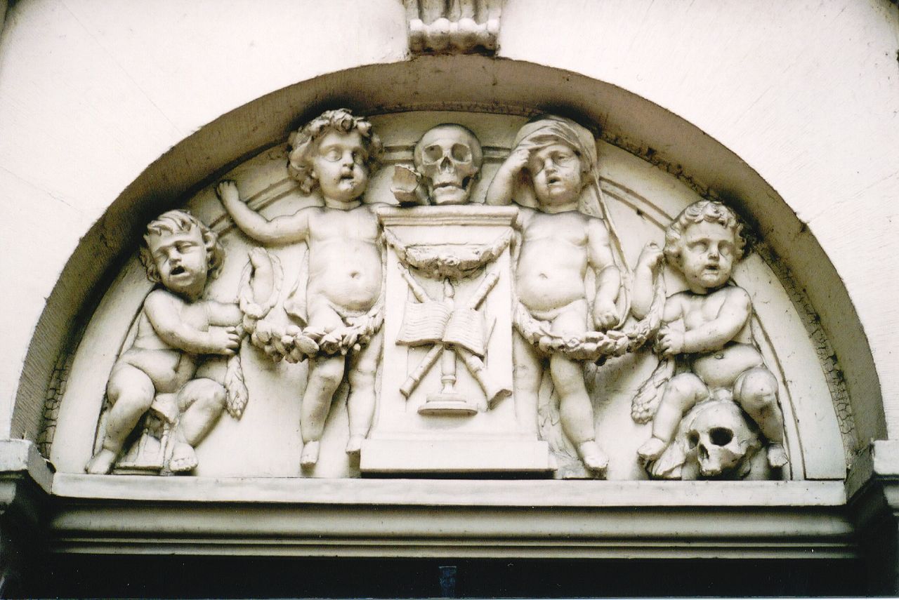 a sculpture depicting a statue of some kind with various figures