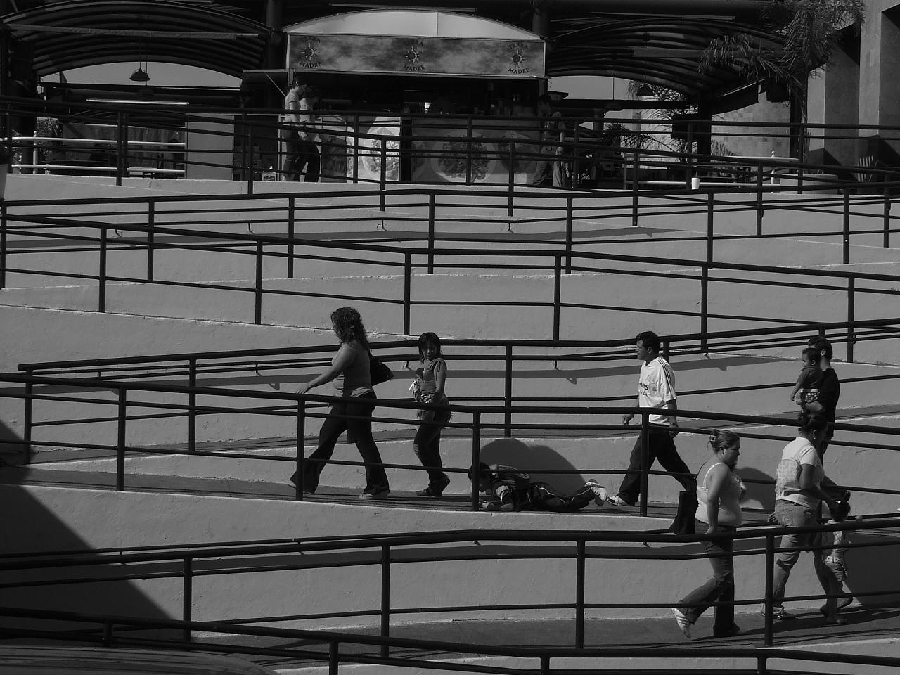 three children walking through an empty parking lot