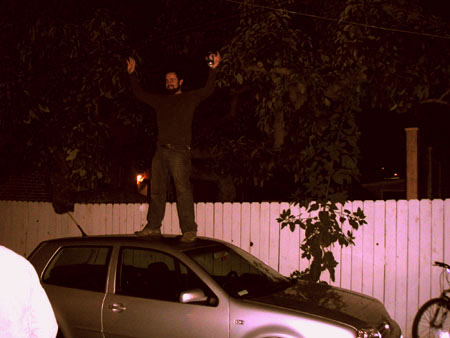 the man is standing on top of the car