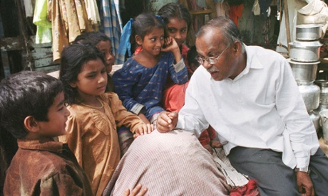 a man sitting in front of a group of children