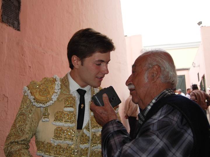 an old man talking to a guy in the foreground