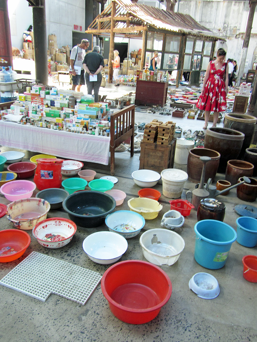 some people are walking around with a lot of bowls on the ground