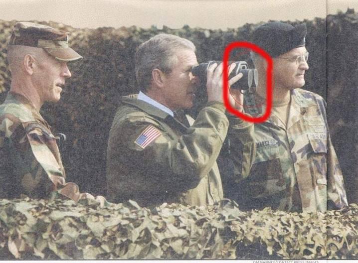 an image of two military men taking pictures of another soldier