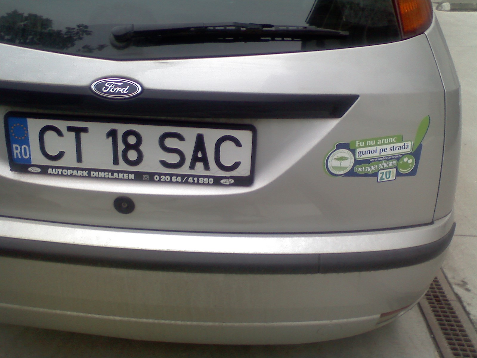 the license plate for a silver car is displayed