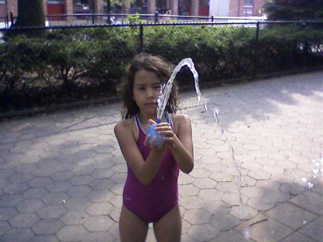 a little girl that is playing in water