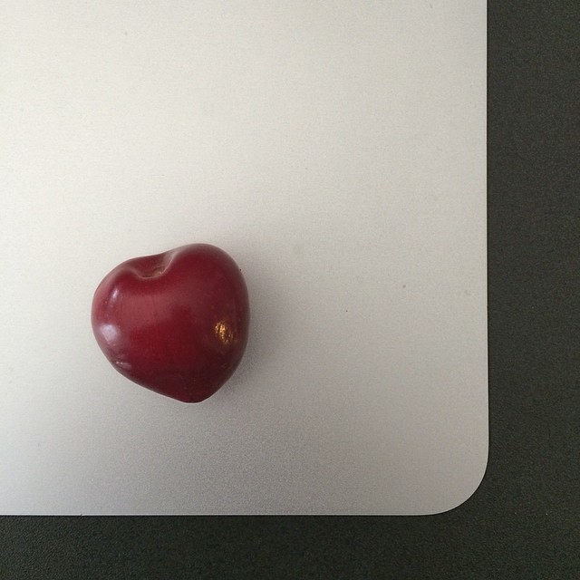 an apple on top of a white chopping board
